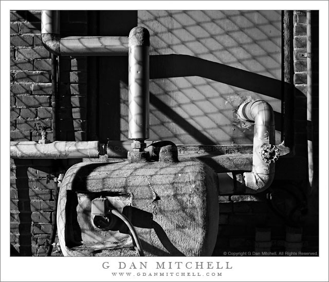 MINSYTankPipesWallFenceShadowsBW20110212